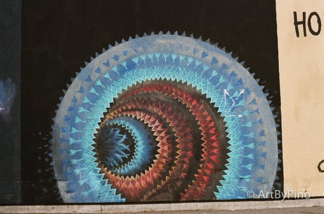 Vibrant blue red spiral mural black center in Texas view fullsize film comparison