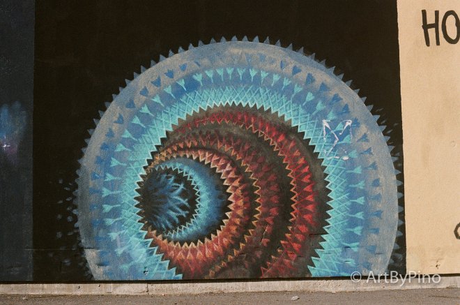 Vibrant blue red spiral mural with jagged edges, Texas view fullsize