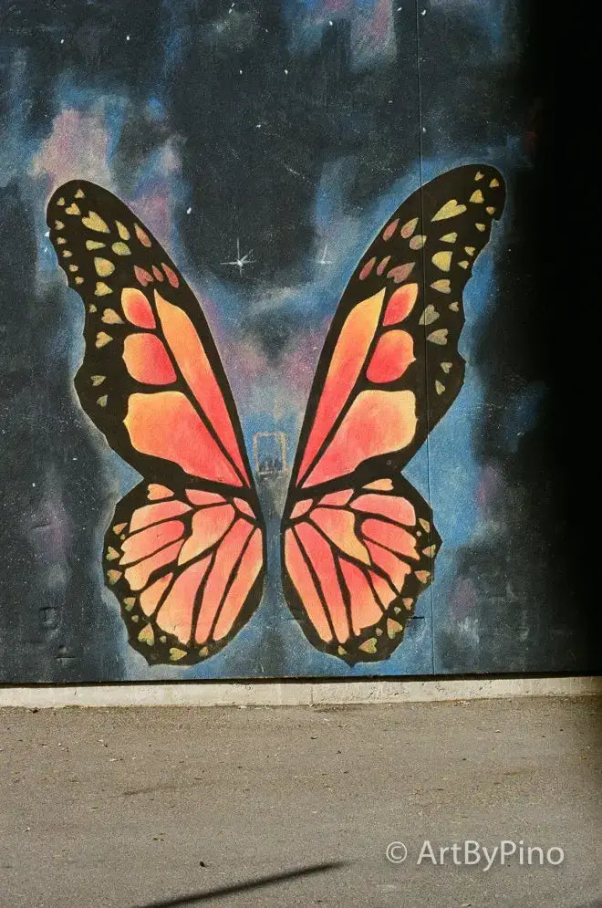 Vibrant monarch butterfly mural on starry sky, view fullsize in Texas film comparison
