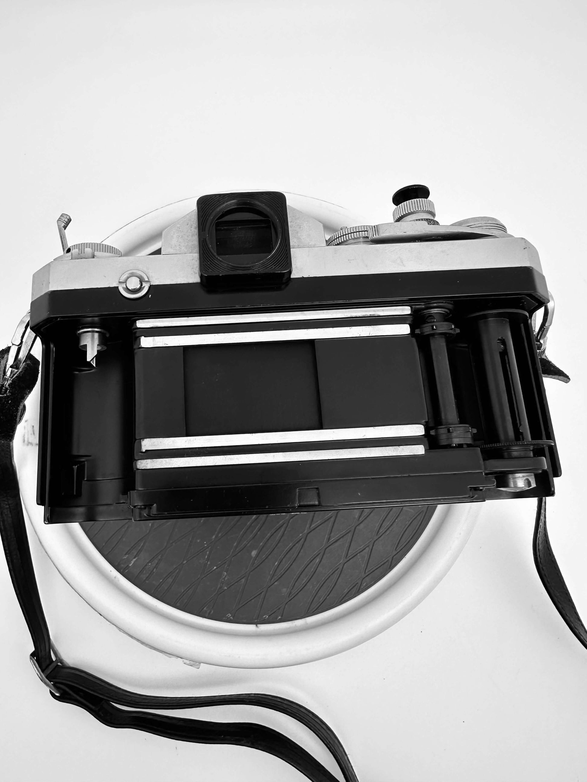 Vintage Nikon F film camera viewed from above, showcasing its back and film compartment.