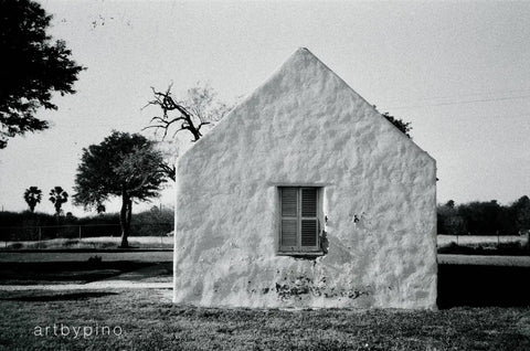 Weathered adobe house captured in film photography