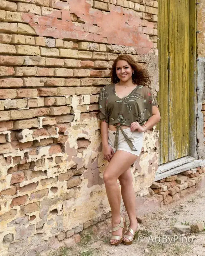 Woman in green patterned blouse and white shorts for best seniors graduation