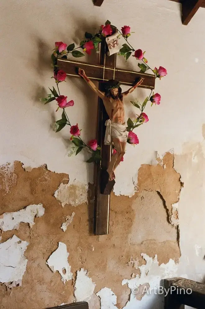 Wooden crucifix with pink roses and n.p. sign on peeling wall, Texas view fullsize