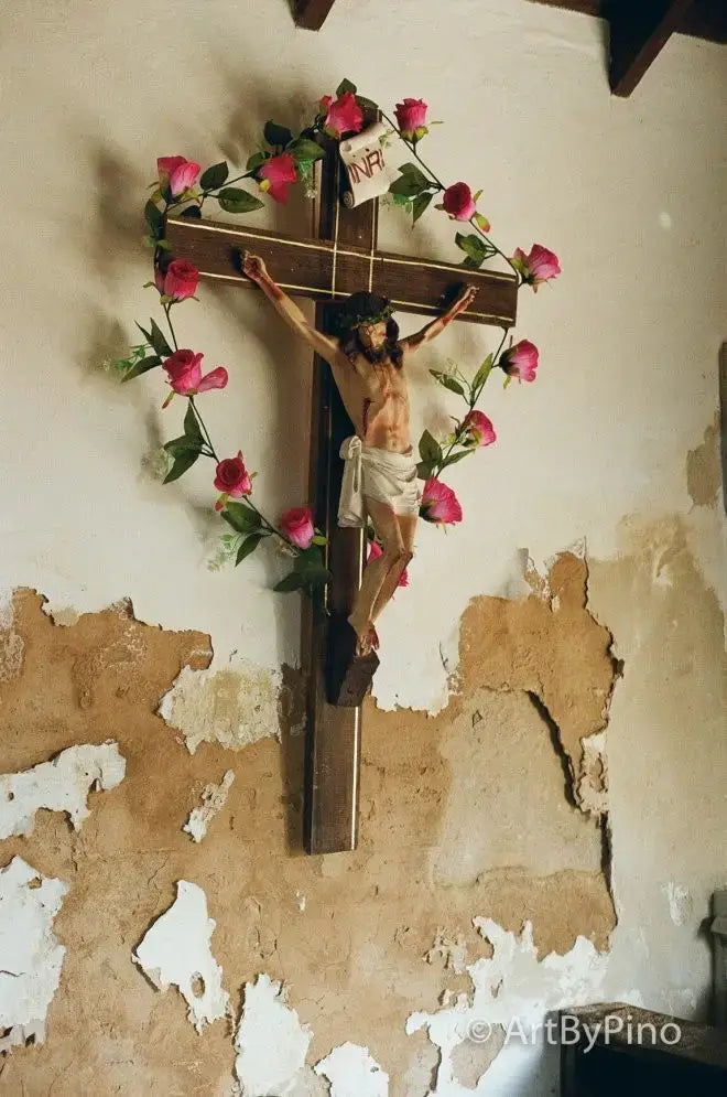 Wooden crucifix with Jesus figure, pink roses, green leaves; view fullsize