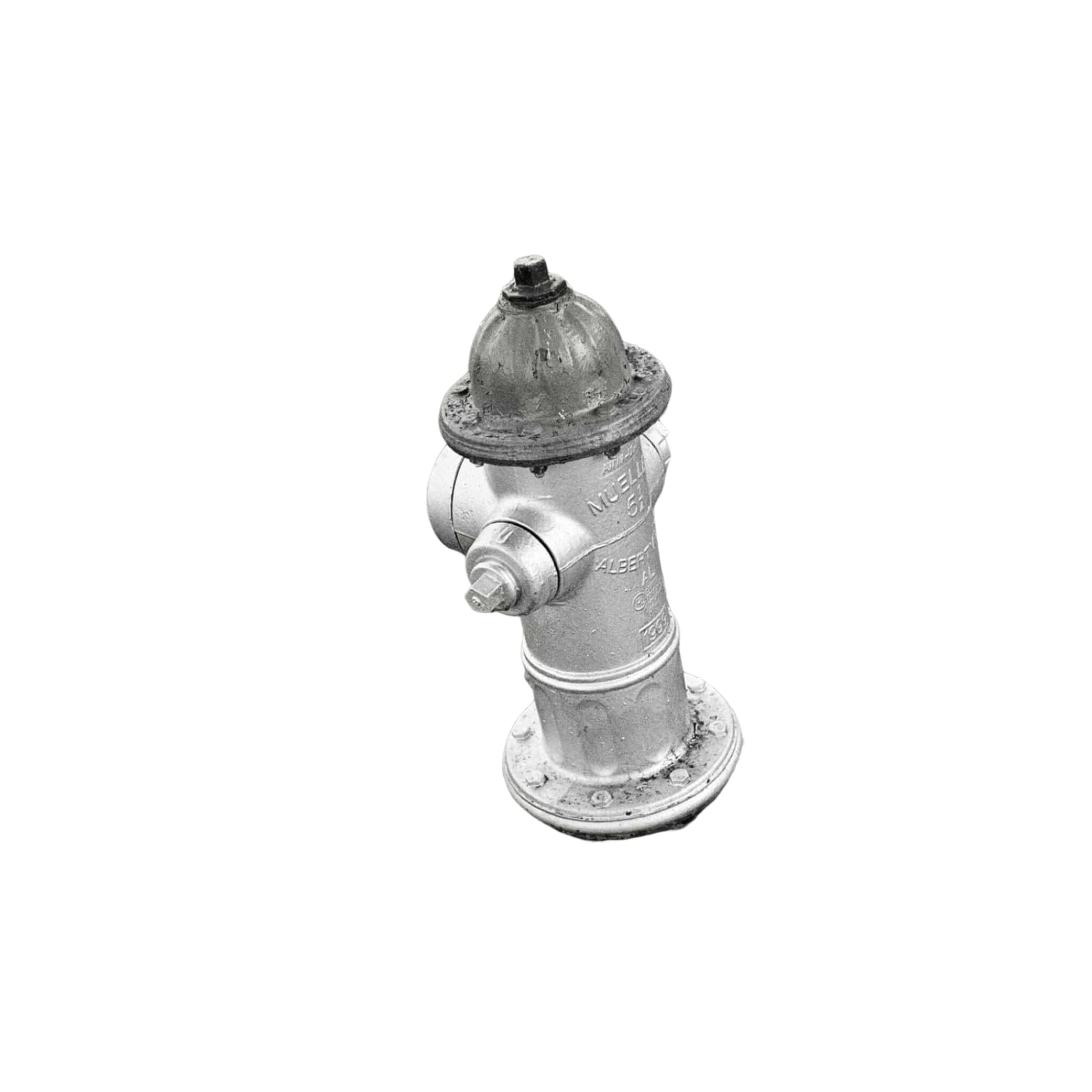 A classic silver fire hydrant with a domed top and bolted caps, standing on a bed of gravel.