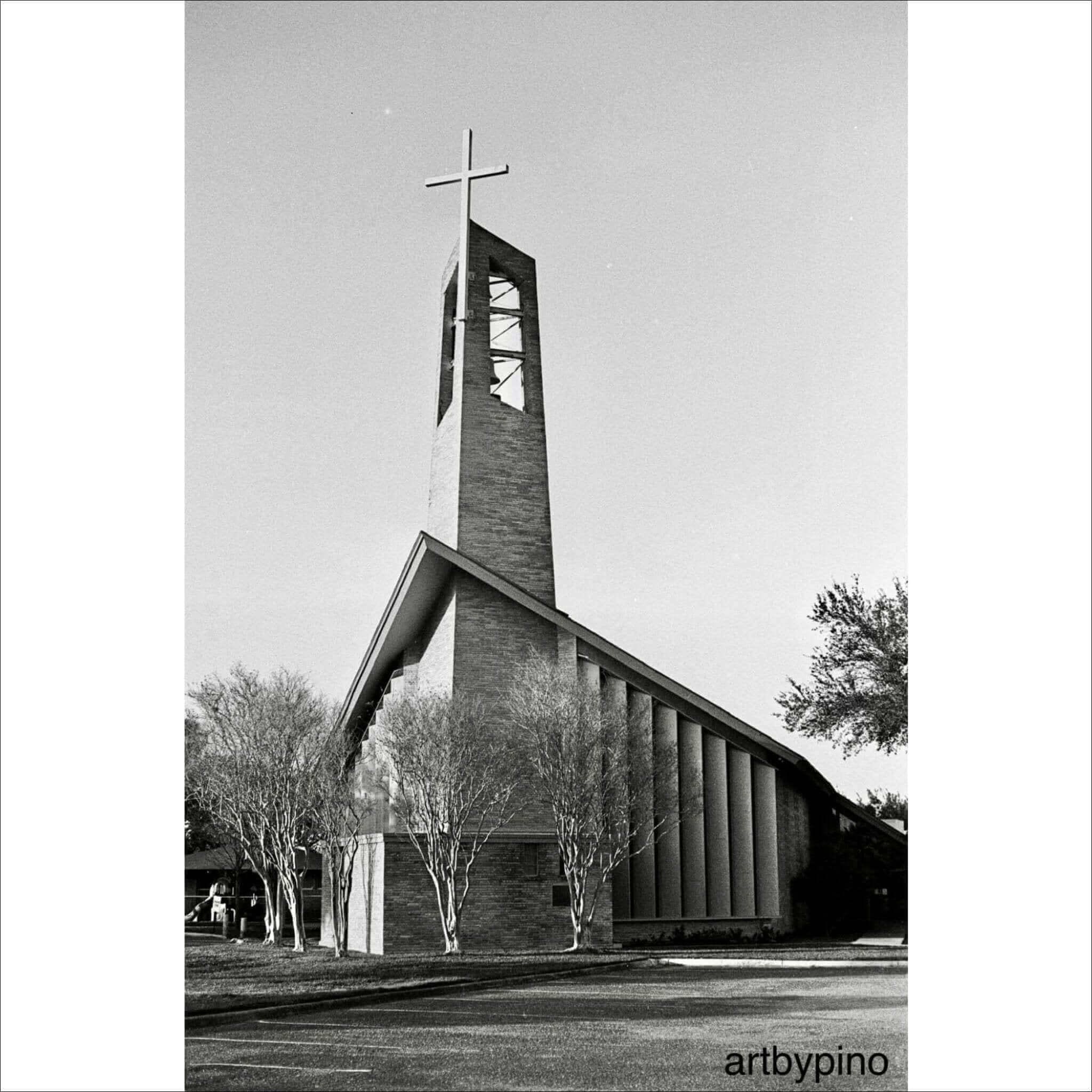 Modern brick church with a tall, angular bell tower topped by a cross.