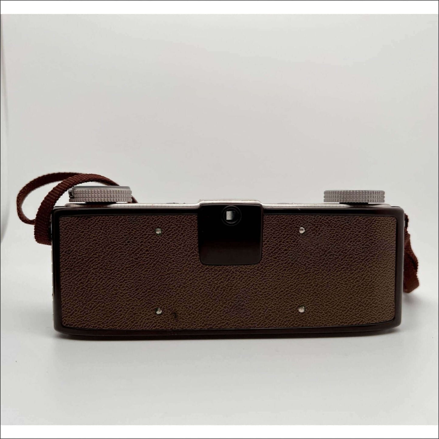 Back view of Kodak Stereo 35mm film camera showing surface details and strap, sold as is with original case.