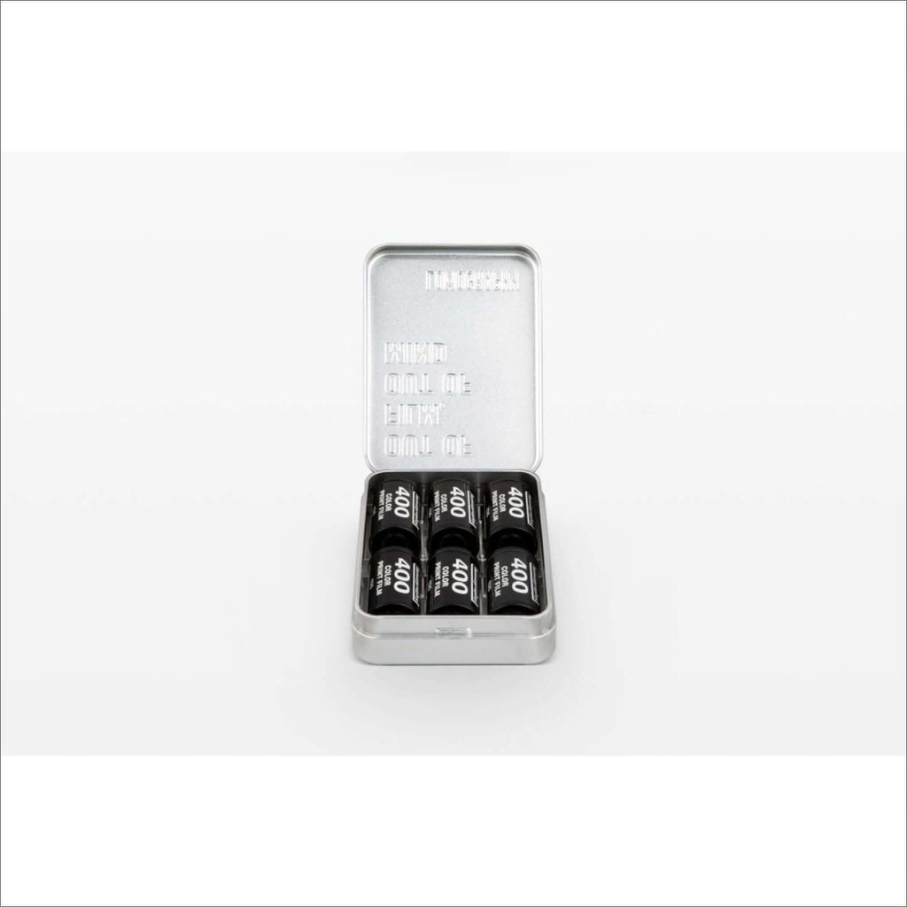 Lomography metal film case tin holding 35mm and 120 film rolls, ideal for photographers to keep films organized and protected.