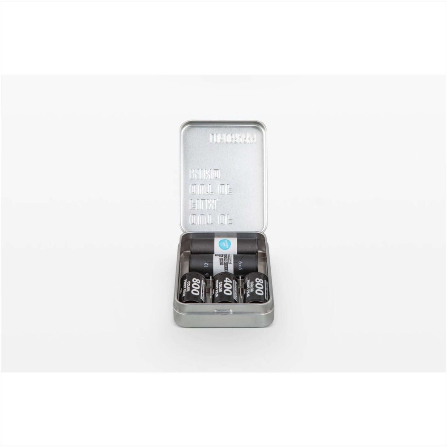 Lomography metal film case tin opened, holding 35mm and 120 film rolls organized and protected.