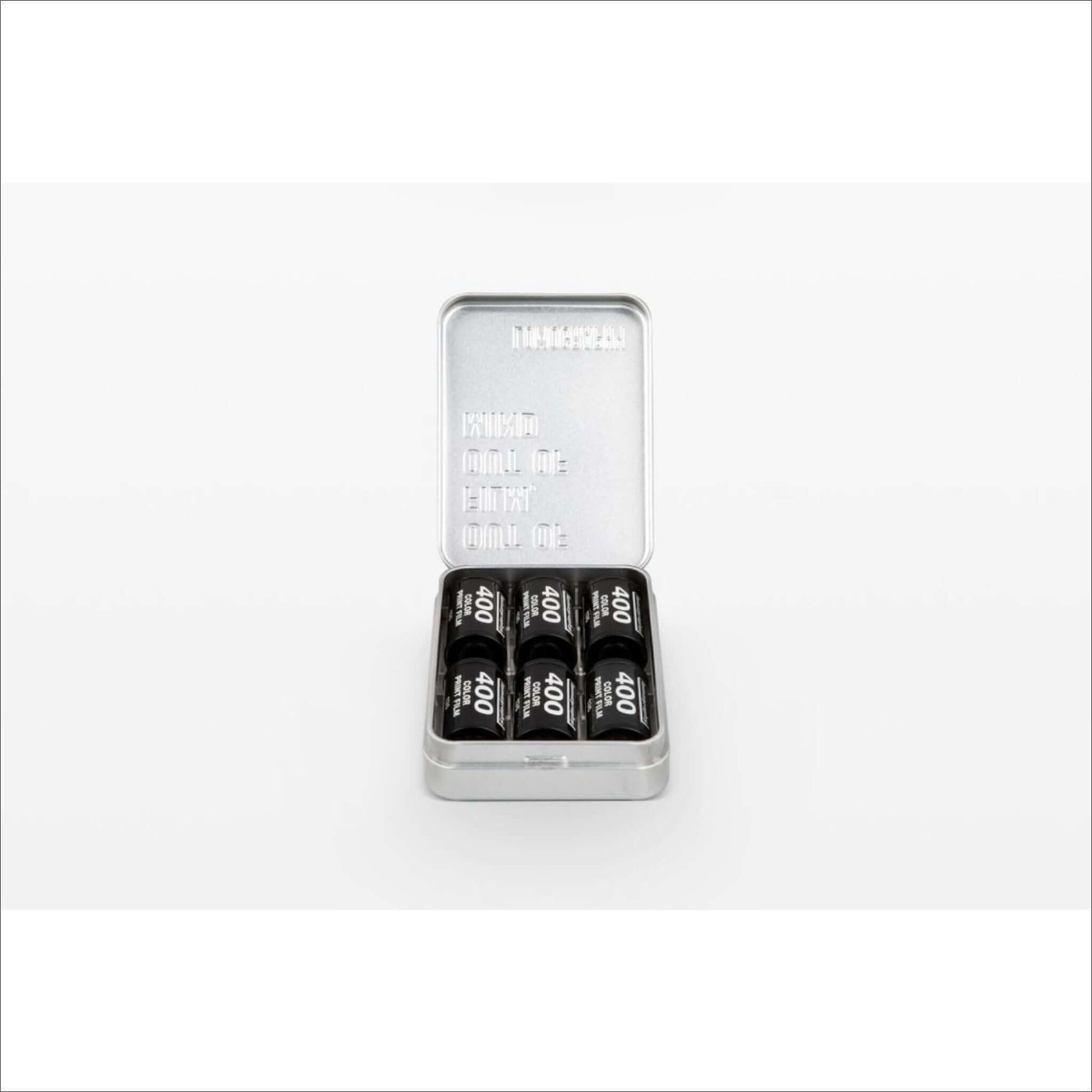 Lomography metal film case tin holding 35mm and 120 film rolls, ideal for photographers to keep films organized and protected.
