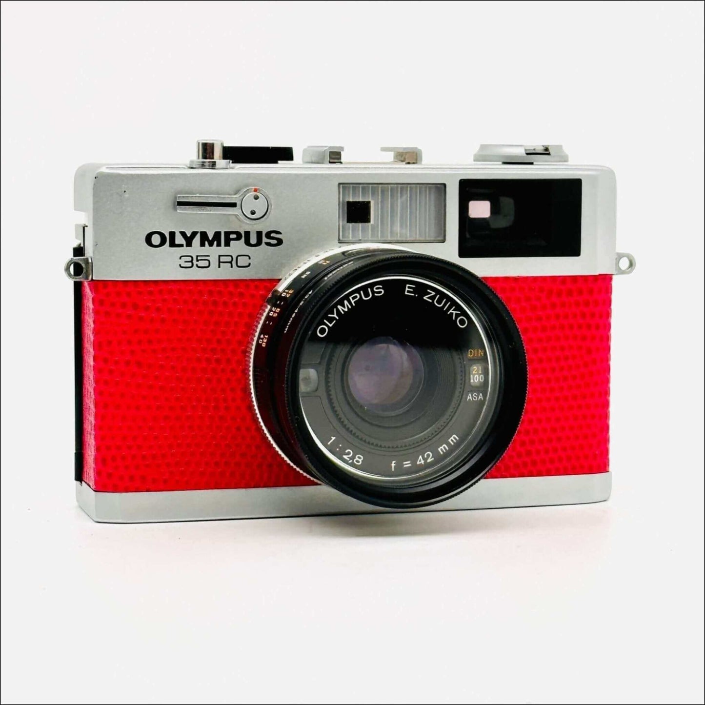 Olympus 35 RC 35mm used pink rangefinder film camera with E. Zuiko lens and retro design.