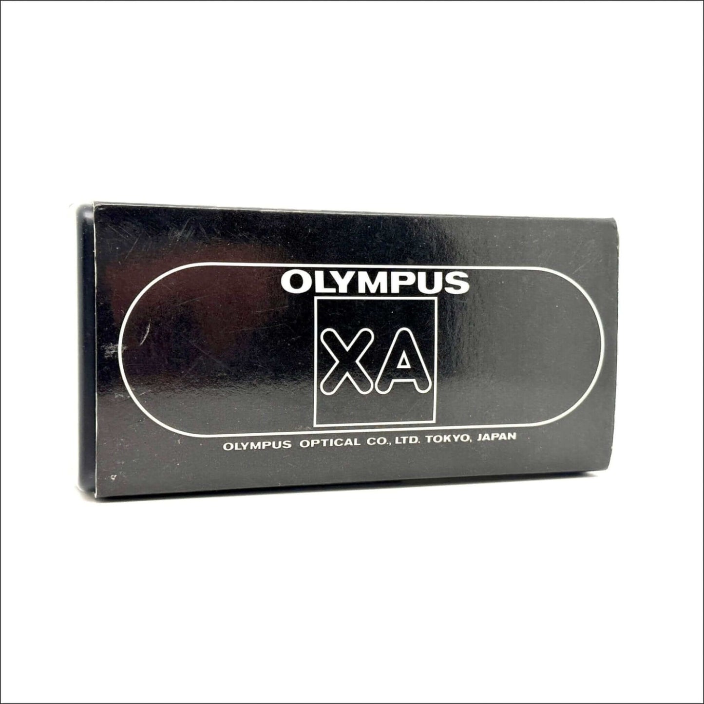 Olympus XA vintage film camera box, featuring the brand logo and text from Olympus Optical Co., Ltd, Tokyo, Japan.