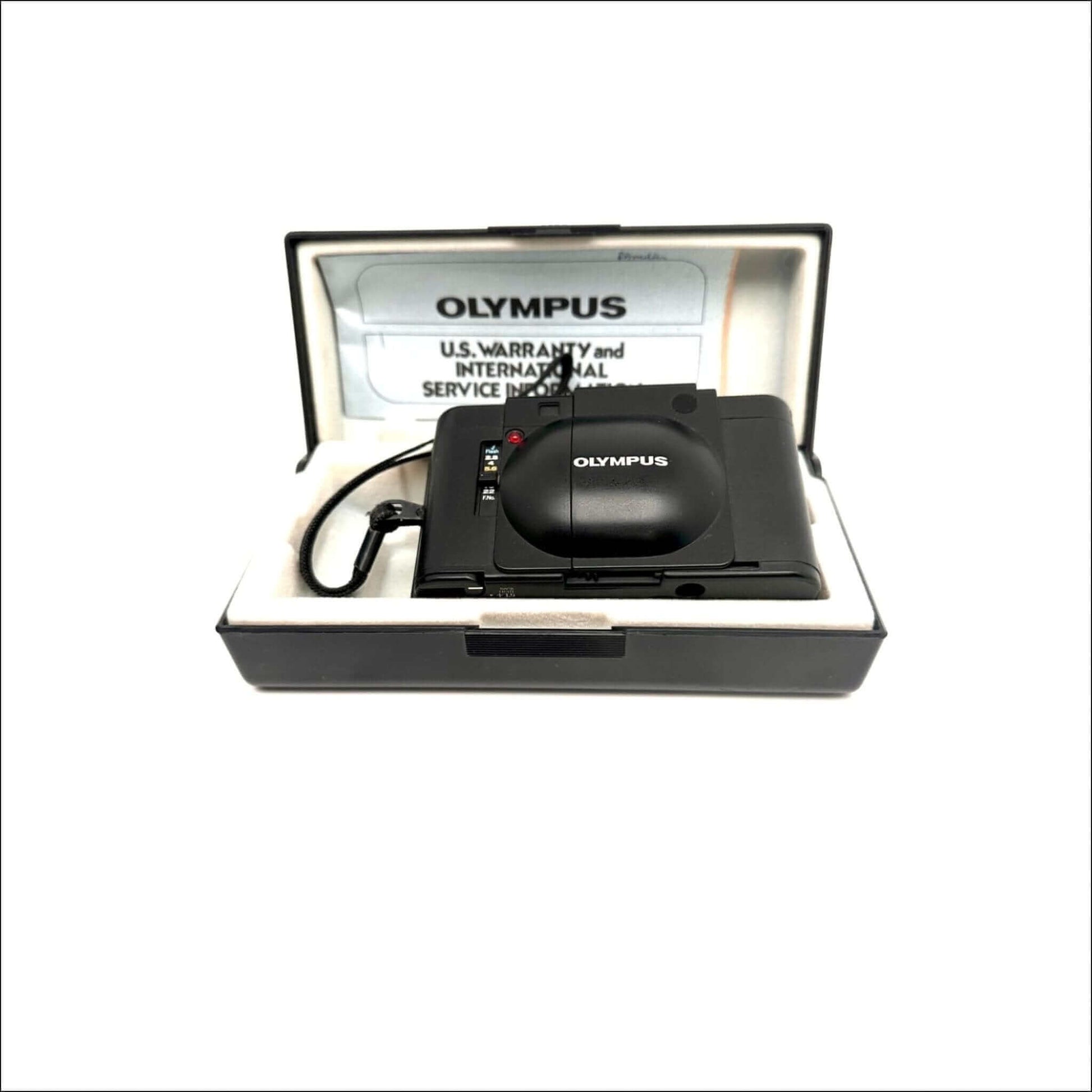 Olympus XA used 35mm vintage film camera in its original box with warranty card, showcasing fine condition and craftsmanship.
