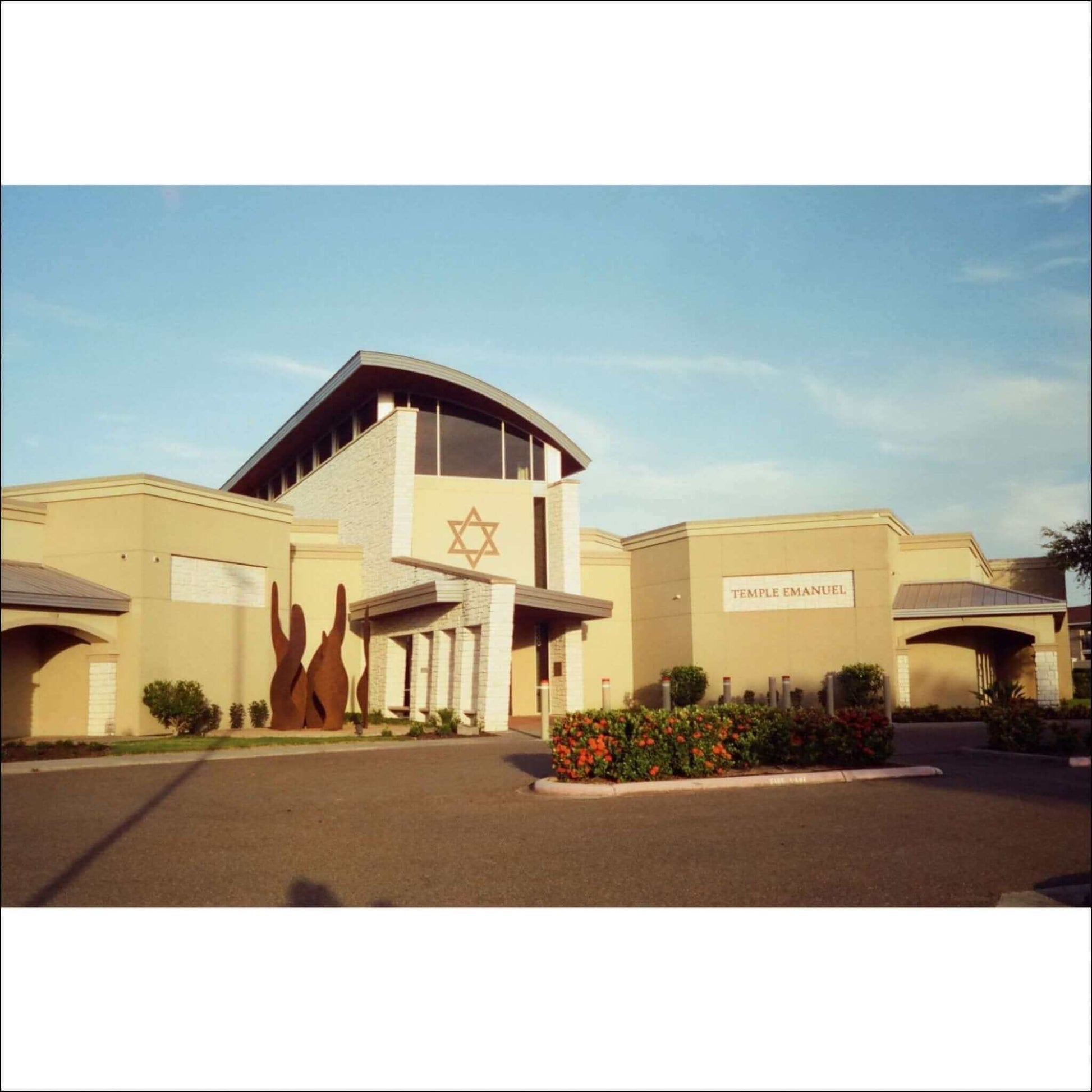 Exterior view of Temple Emanuel featuring modern architecture and a Star of David design.